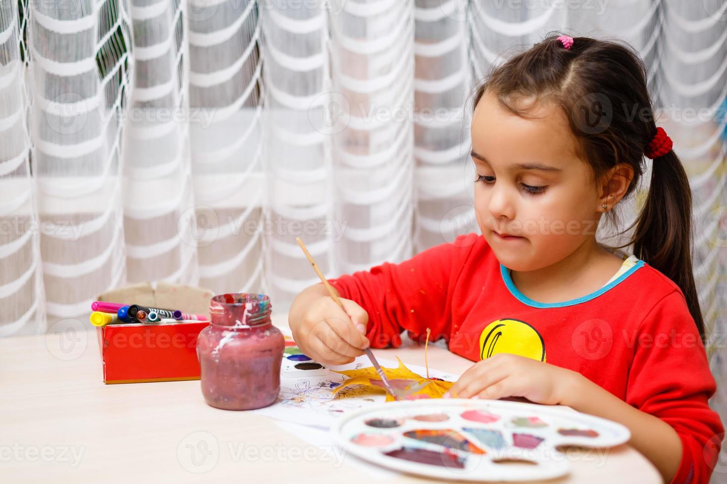 weinig meisje schilderij Aan herfst geel bladeren met gouache kinderen kunsten kinderen creativiteit herfst kunst foto