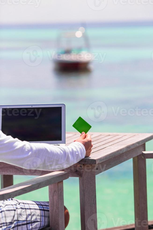 dichtbij omhoog van computer en credit kaart Aan de tafel foto