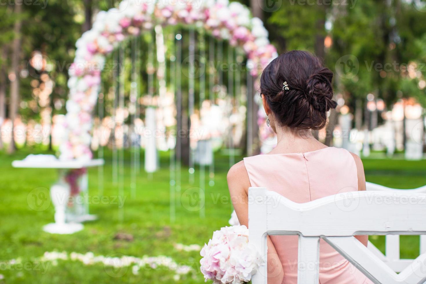 terug visie van mooi jong vrouw in een lang jurk Bij de ceremonie buitenshuis foto