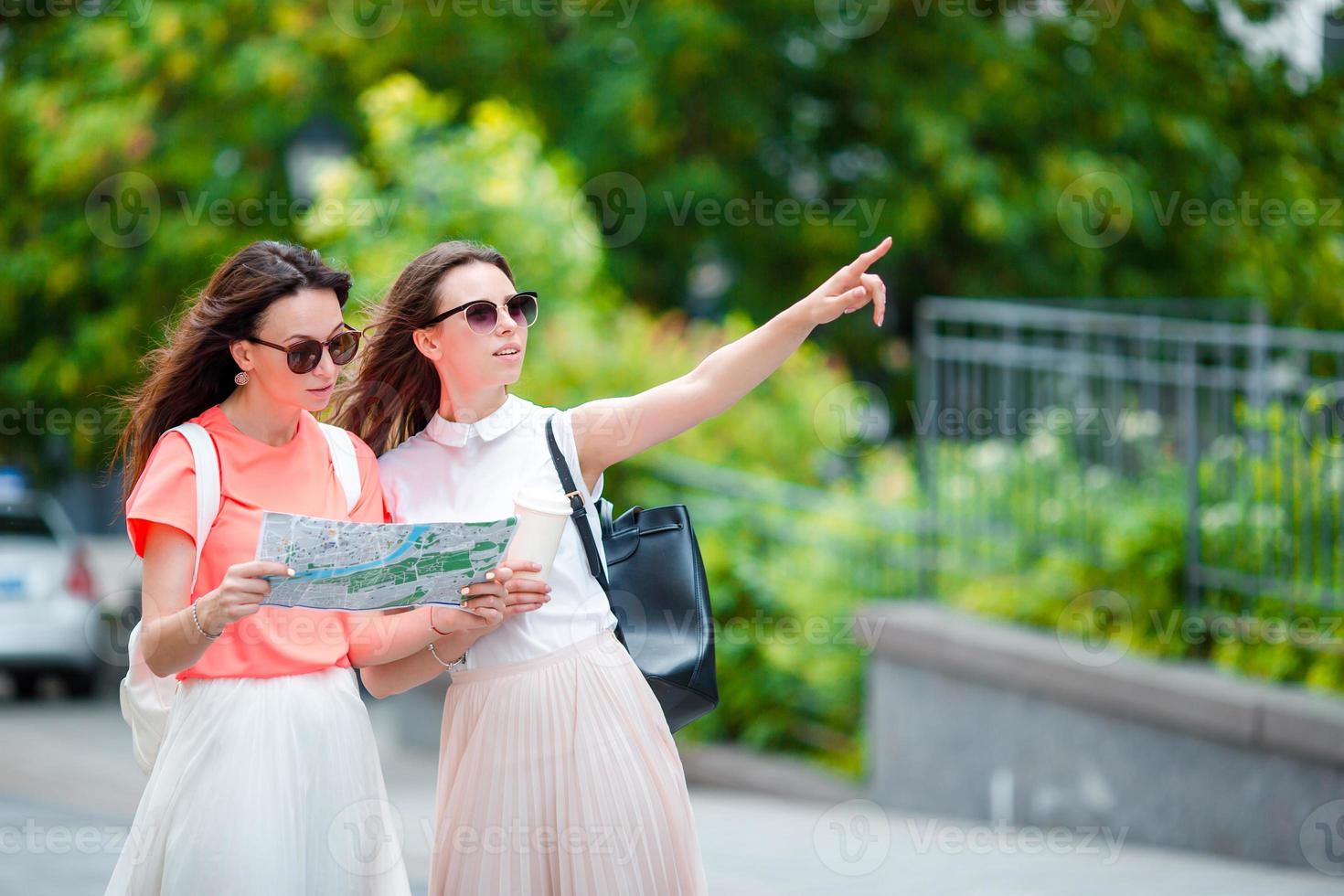 gelukkig jong Dames met boodschappen doen Tassen wandelen langs stad straat. uitverkoop, consumentisme en mensen concept. foto