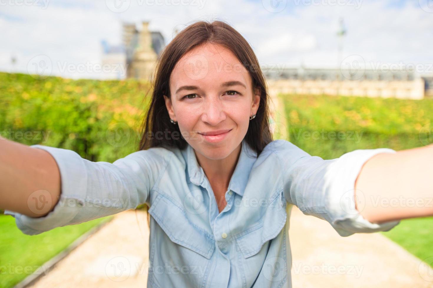 jong vrouw nemen selfie met mobiel telefoon buitenshuis in Parijs foto