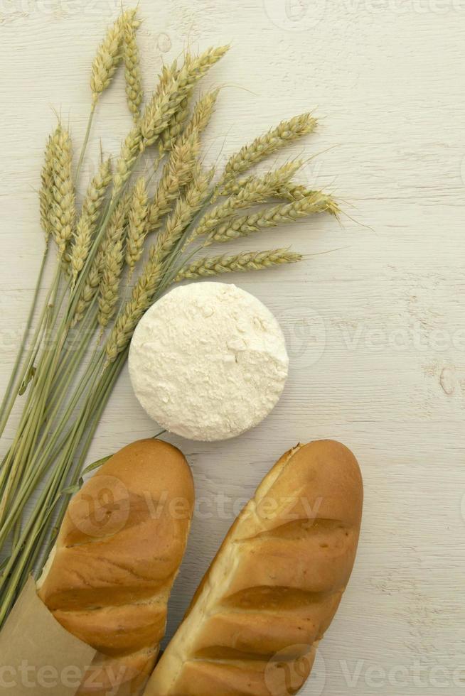eigengemaakt vers brood met tarwe oor Aan wit hout tafel. foto