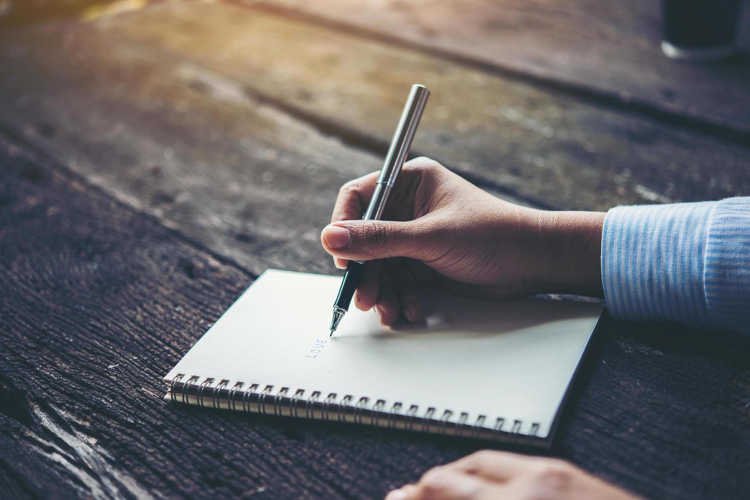 vrouw schrijven in notitieblok foto