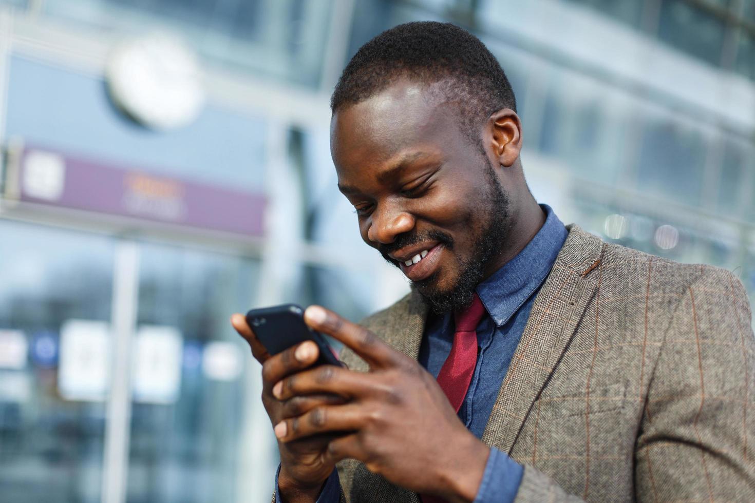 man lacht tijdens het sms'en foto