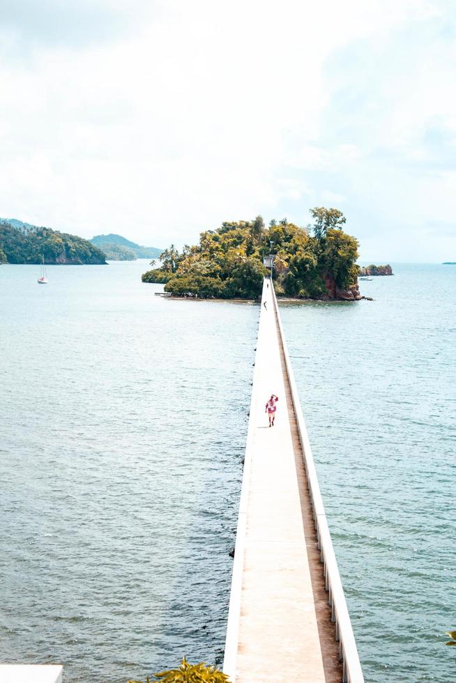 persoon die op een brug naar een eiland loopt foto
