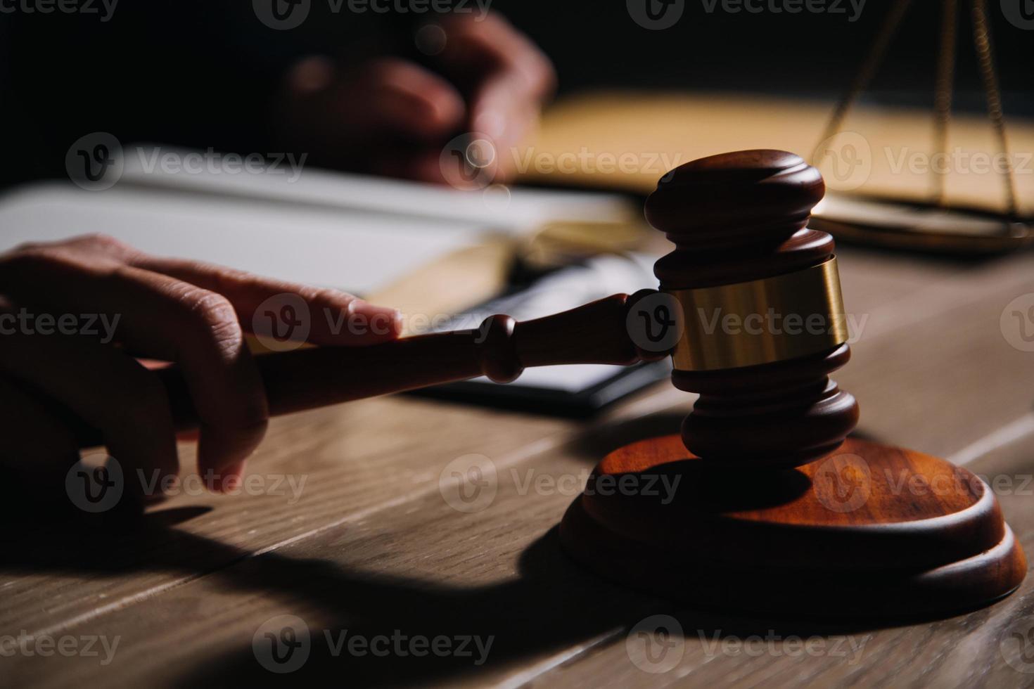 rechtvaardigheid en recht concept.male rechter in een rechtszaal met de hamer, werken met, computer en docking toetsenbord, brillen, op tafel in ochtendlicht foto