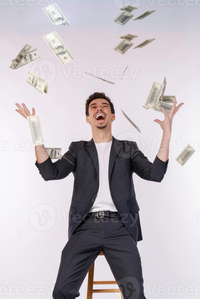 portret van gelukkig jong Mens het werpen geld omhoog terwijl staand geïsoleerd achtergrond foto
