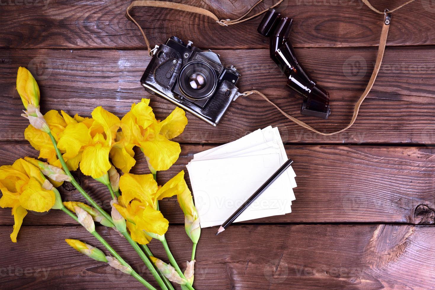 oud film camera en een boeket van geel irissen foto