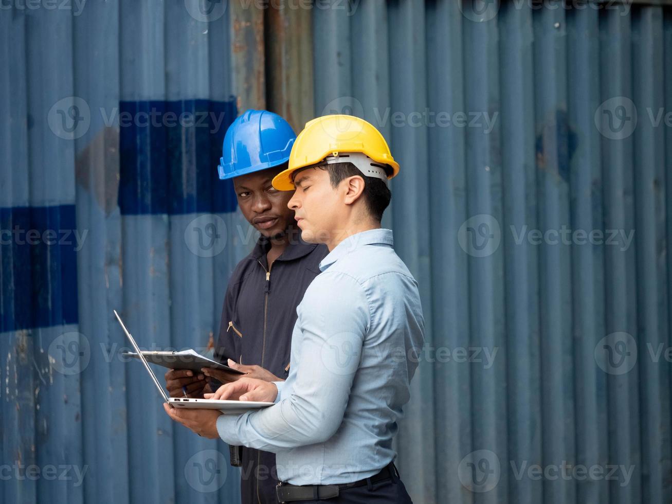 zakenman manager bedrijf geel harde hoed helm veiligheid praten spreken gesprek discussie raadplegen ingenieur arbeid personeel leidinggevende fabriek notitieboekje verslag doen van informatie verslag doen van bedrijf importeren exporteren foto