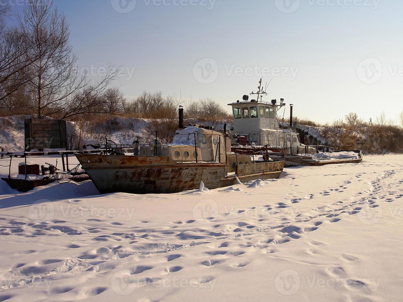 een oud verroest Russisch boot wrak in sneeuw foto