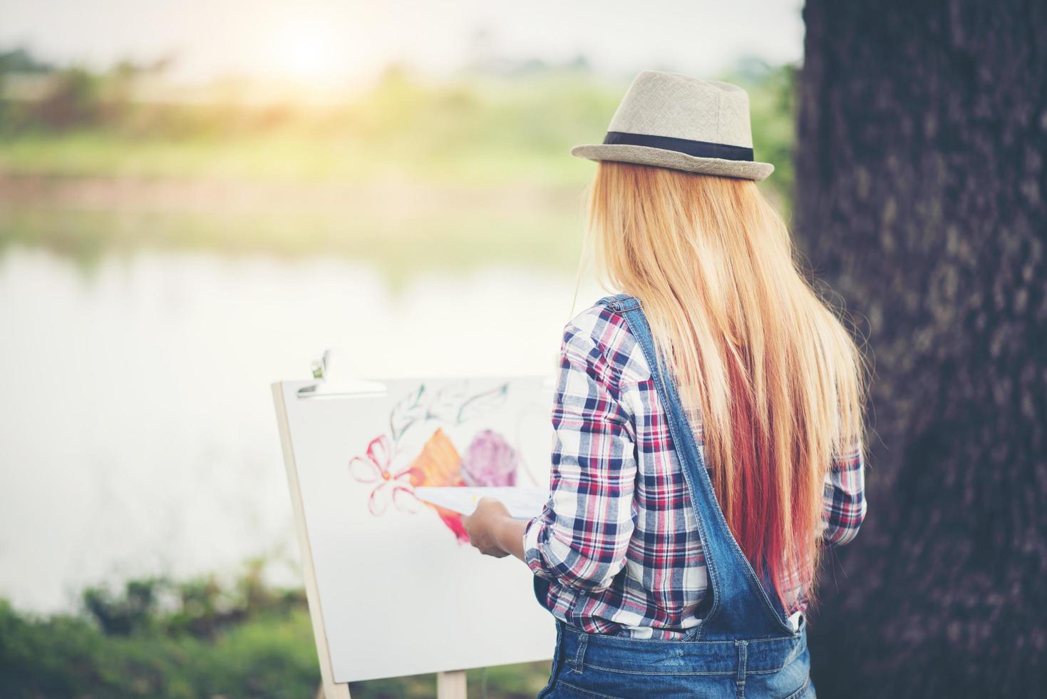 jonge vrouw tekent een foto in het park