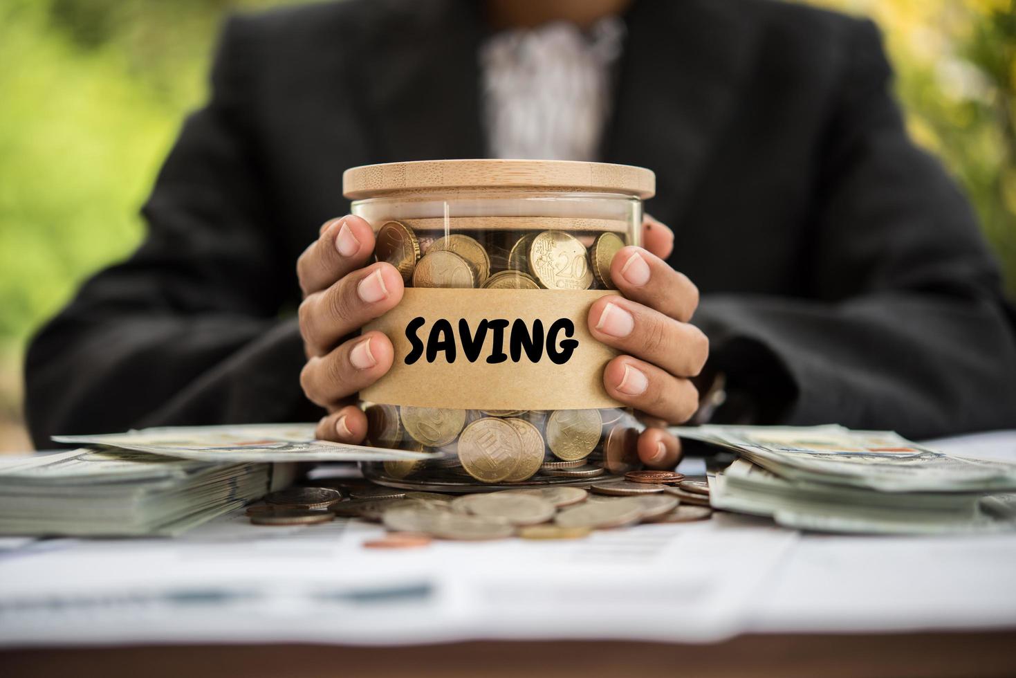 geld in een glazen pot in de natuur, investeringsconcept foto