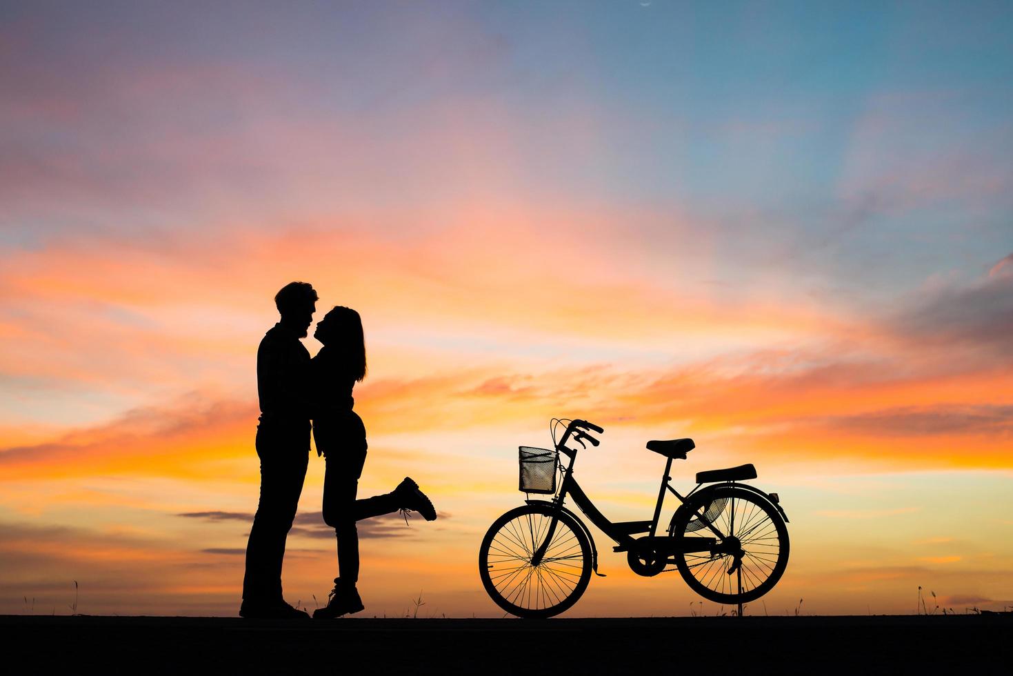 silhouet van een jong koppel samen tijdens zonsondergang foto