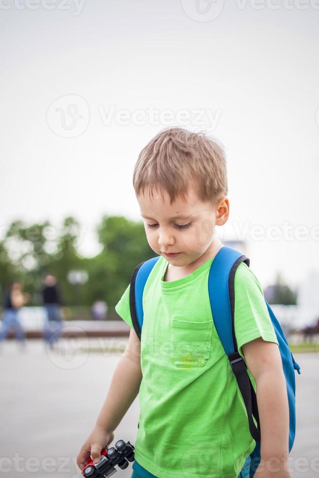 portret van een kind, een jongen tegen de backdrop van stedelijk landschappen van wolkenkrabbers en hoogbouw gebouwen in de Open lucht. kinderen, reizen. levensstijl in de stad. centrum, straten. foto