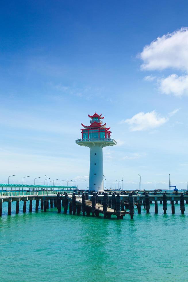 vuurtoren en brug die zich uitstrekt in de zee foto