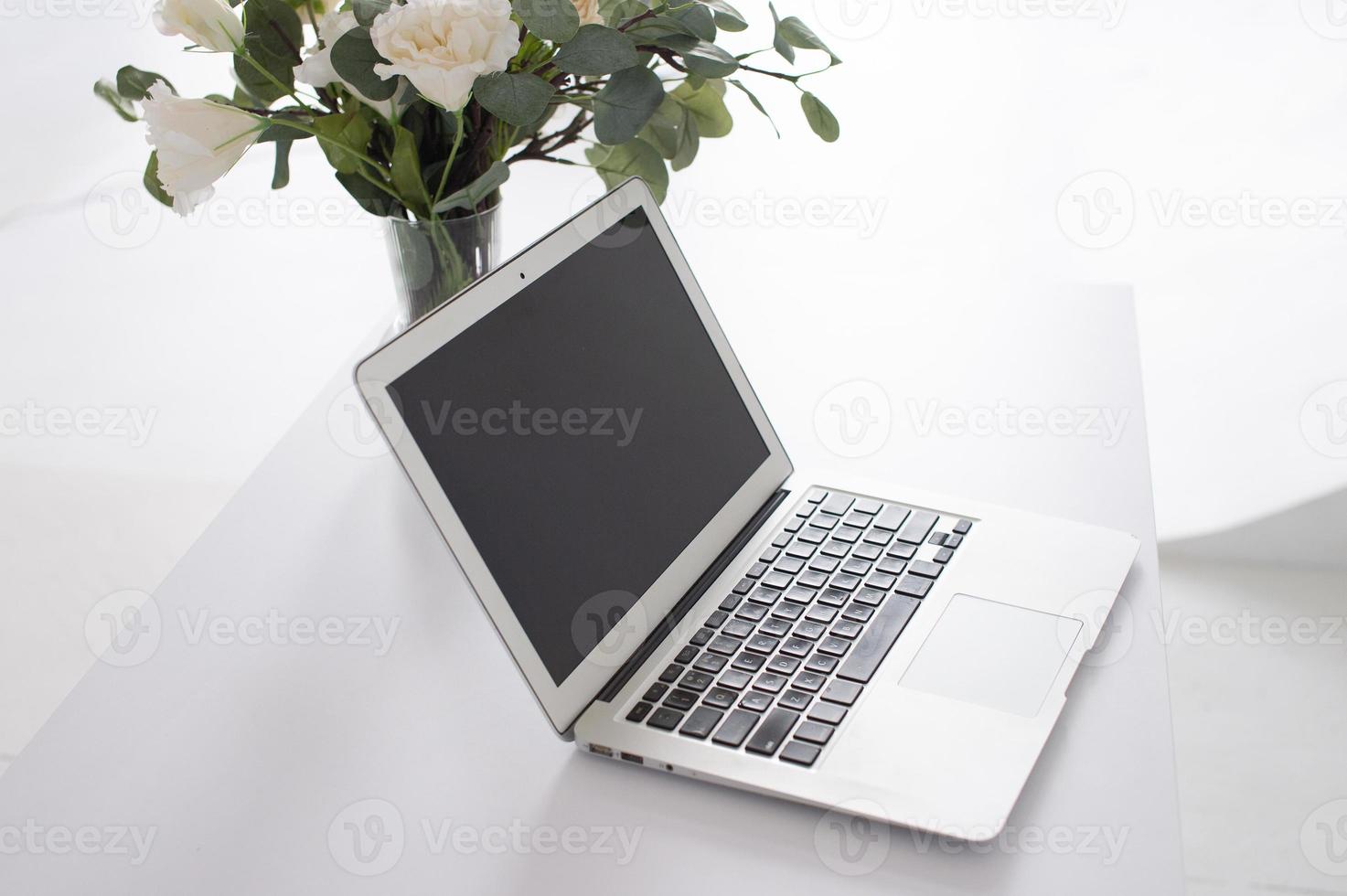 grijs laptop Aan een wit bureau Open foto