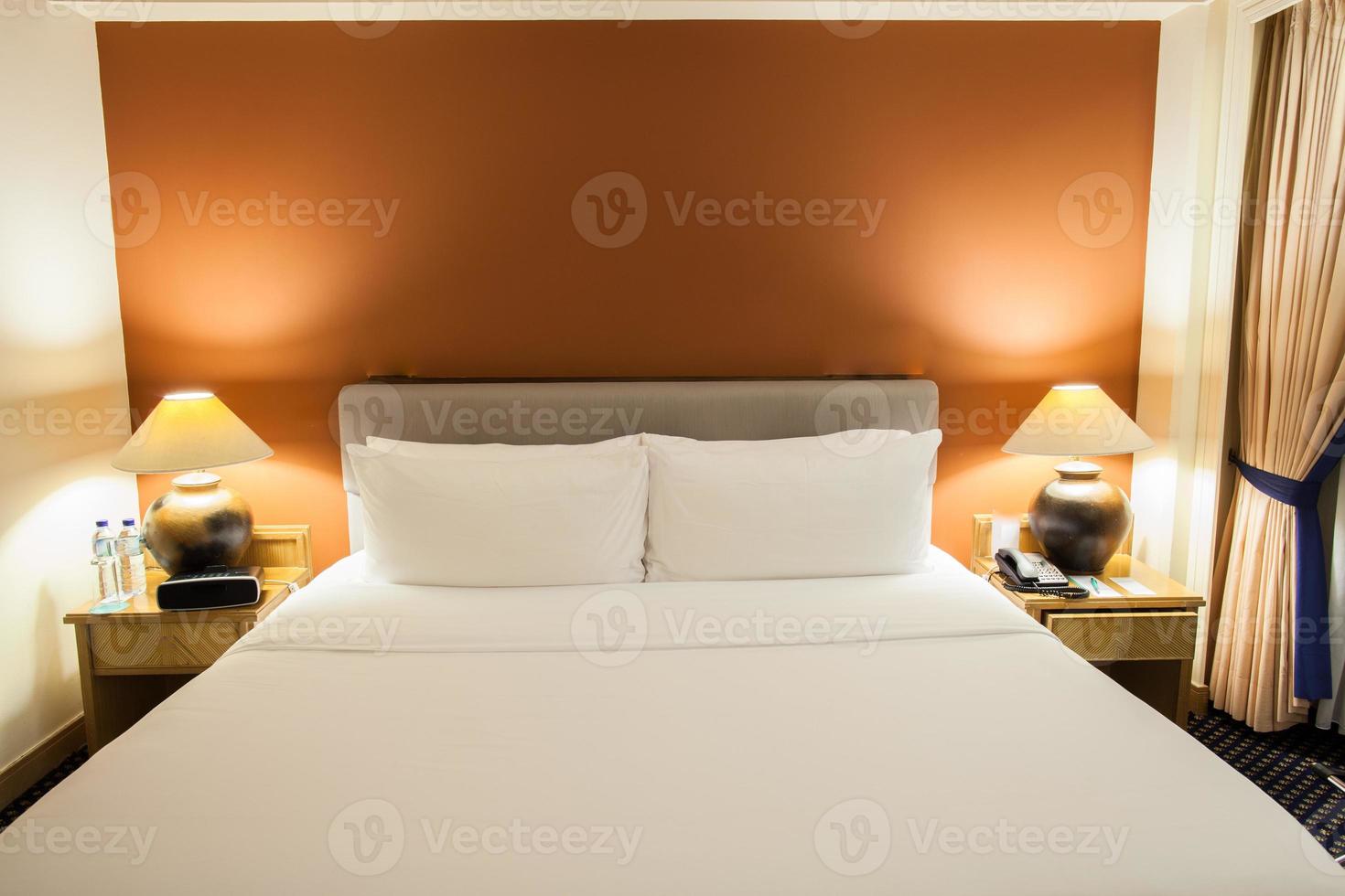 hotelbed en een oranje muur foto