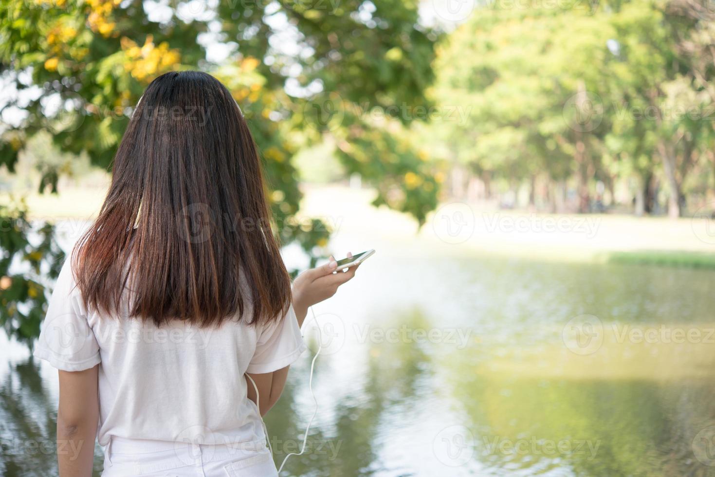 achterzijde van jonge vrouw ontspannen in het park foto