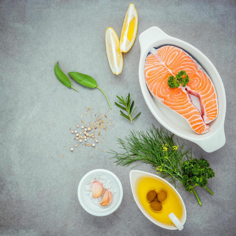 zalm en verse ingrediënten op een grijze achtergrond foto