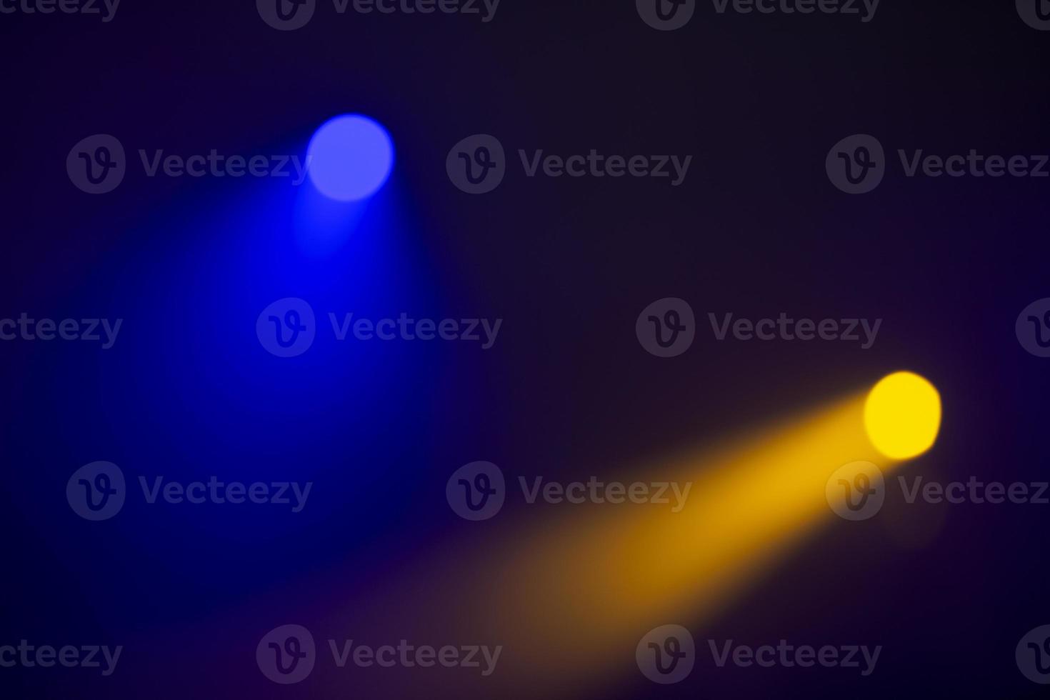 oranje balken van licht van stadium schijnwerpers Aan een donker blauw achtergrond.verlichting van de fase. foto
