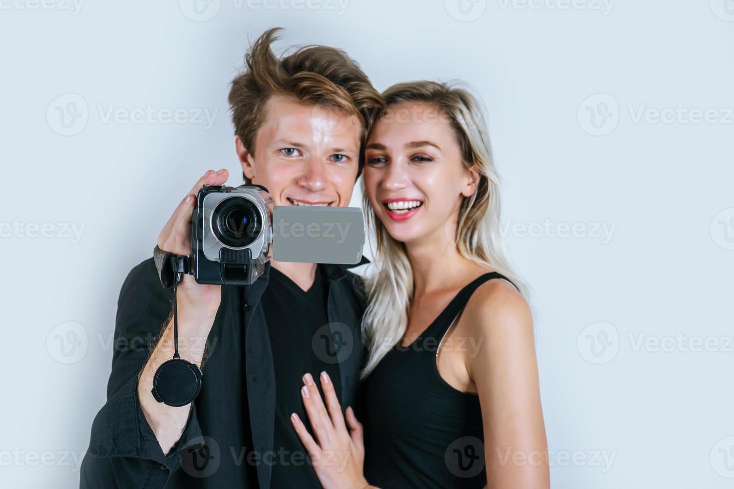 gelukkig portret van een paar videocamera houden en een video opnemen foto