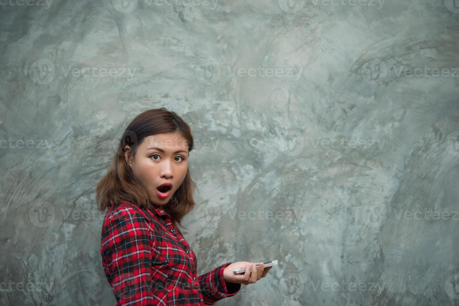 jonge hipster vrouw met smartphone geïsoleerd op grunge achtergrond foto