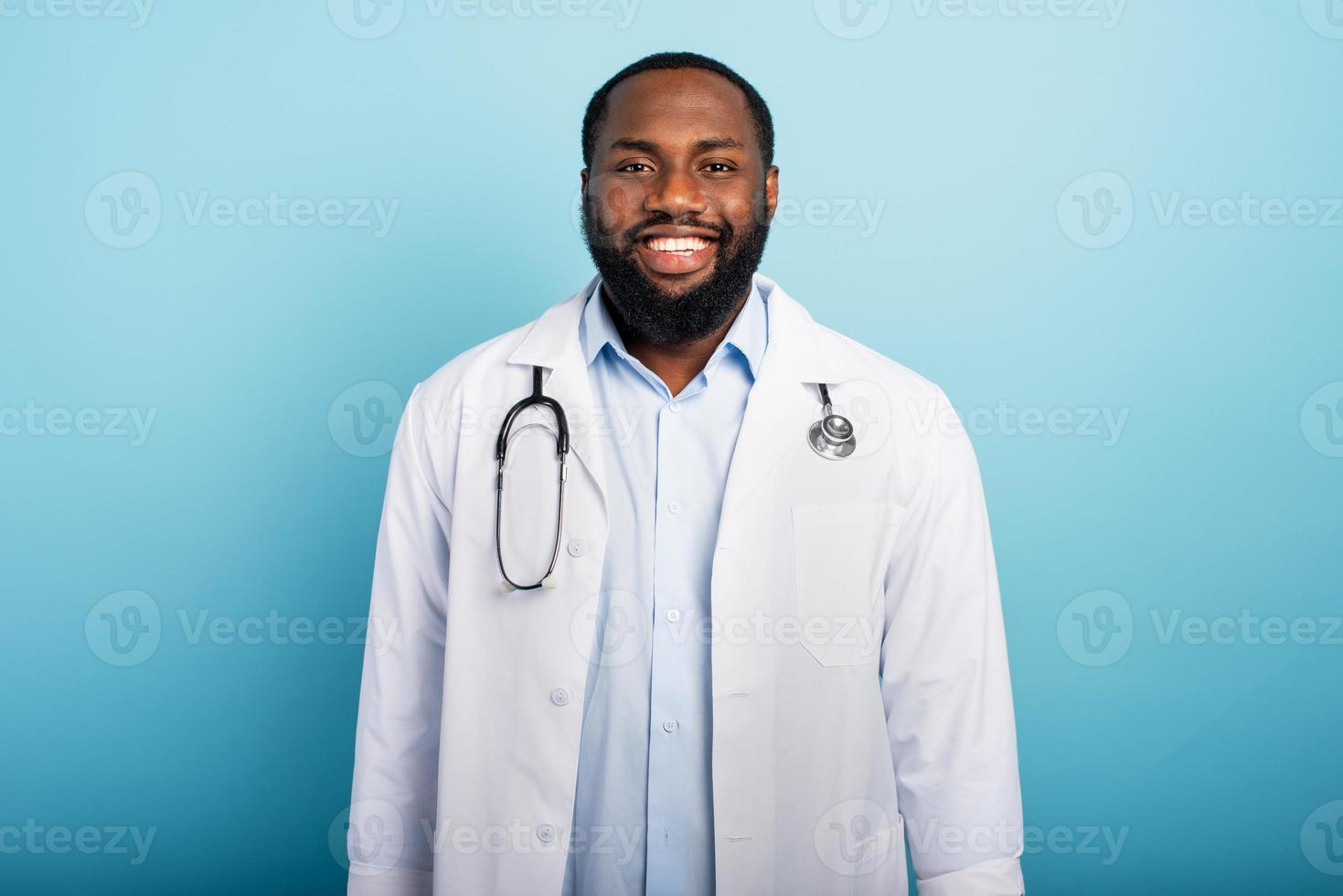 dokter is gelukkig omdat de noodgeval van coronavirus covid-19 zijn afwerking. licht blauw achtergrond foto