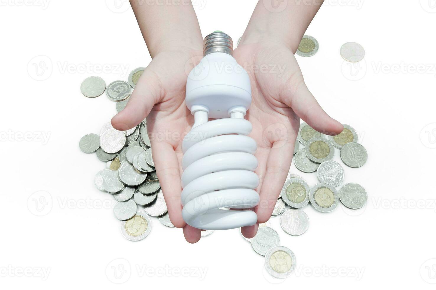 energie besparing concept, vrouw hand- Holding licht lamp Aan munt Aan wit achtergrond, ideeën licht lamp in de hand- foto