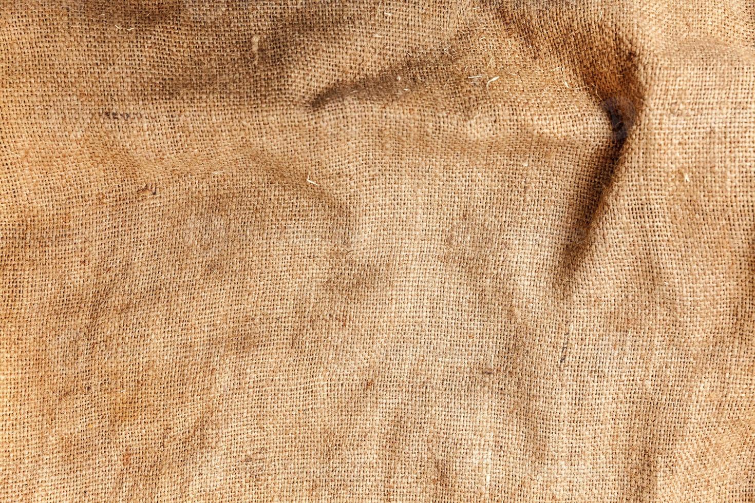 pastel abstract jute of zak jute geweven kleding stof structuur achtergrond in geel beige room sepia bruin kleur foto