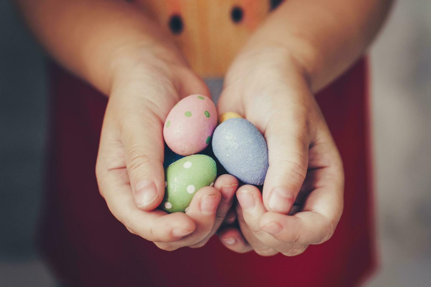 weinig meisje handen Holding Pasen eieren geschilderd kleur Aan hand- foto