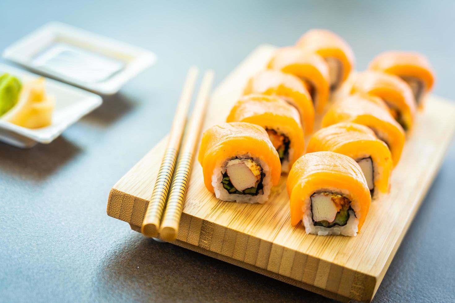 zalmsushi rolt op houten plaat foto