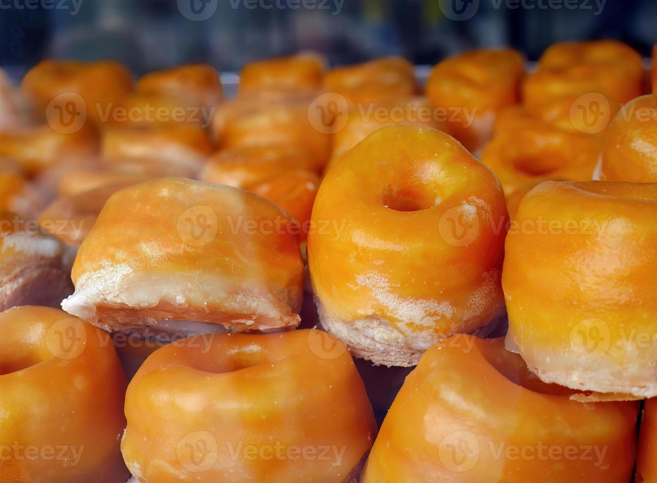 dichtbij omhoog selectief focus typisch toetje deeg in alcalá stijl, rosquillas de alcala, bladerdeeg gebakje met geel ei dooier coating met siroop, ring gevormd, donuts, in gebakje winkel foto