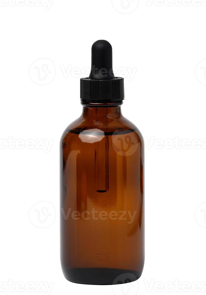 een glas bruin fles met een druppelaar Aan een wit geïsoleerd achtergrond, een houder voor kunstmatig producten foto