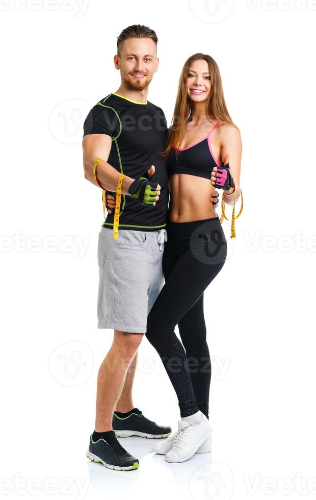 Mens en vrouw met meten plakband Aan de wit achtergrond foto