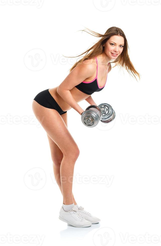 gelukkig atletisch vrouw met halters aan het doen sport oefening, geïsoleerd Aan wit foto