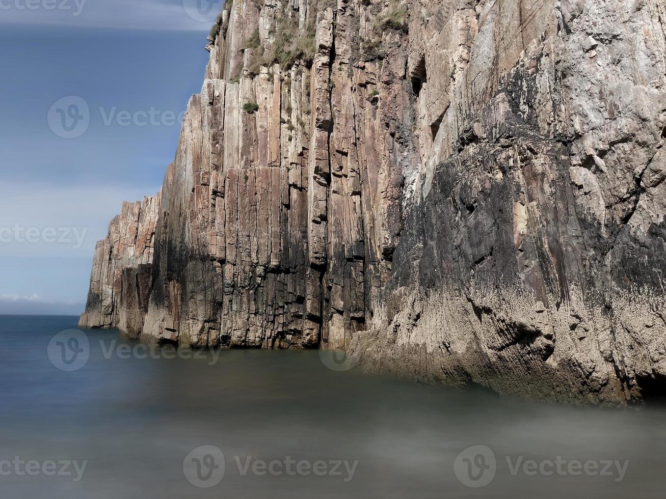 rotsen met rechte randen bij eb van een strand aan de Asturische kust foto