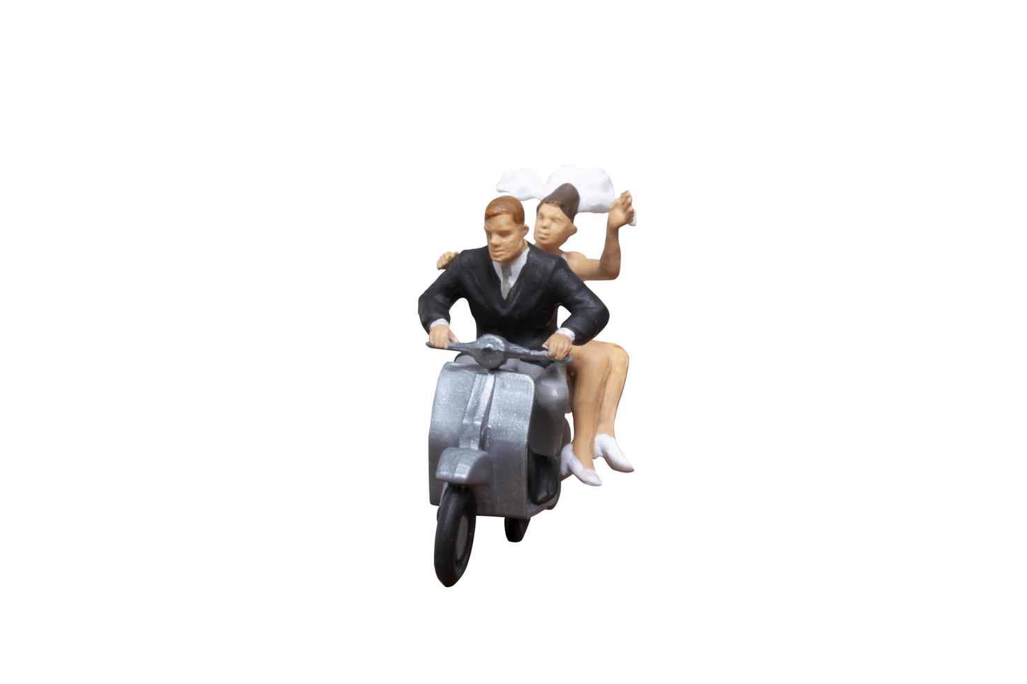 miniatuurpaar rijden op een motorfiets op geïsoleerd op een witte achtergrond foto