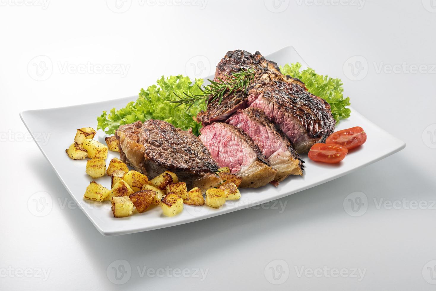 Fiorentina T-bone steak gesneden op rechthoekige witte plaat foto