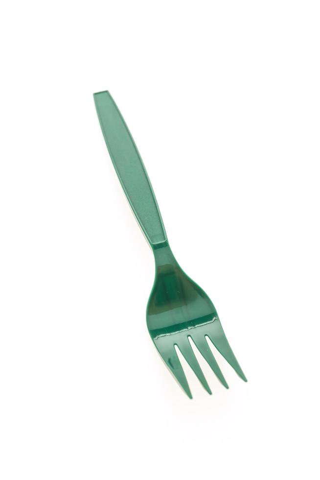 groene plastic vork op witte achtergrond foto
