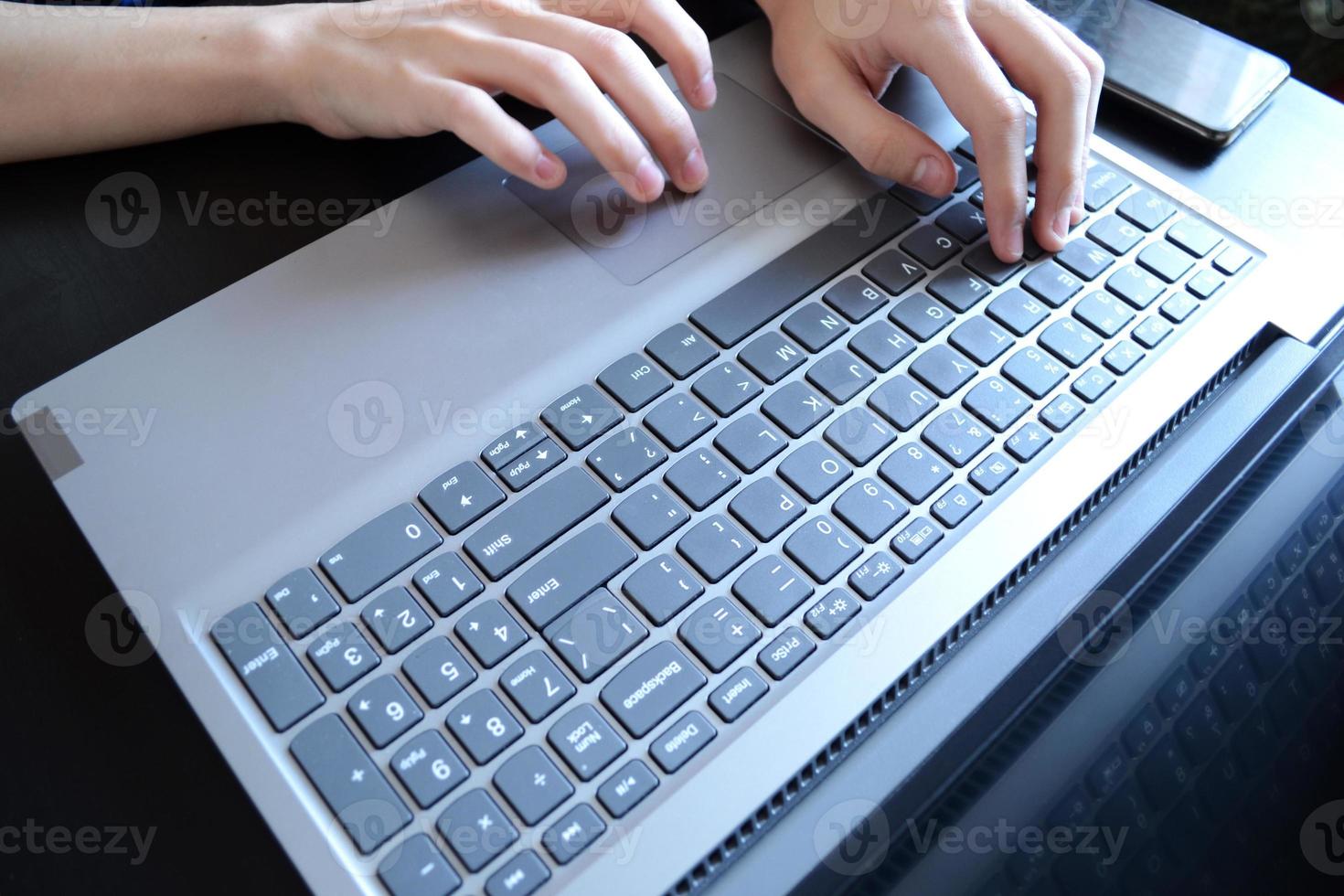 top visie van handen typen Aan een laptop, een persoon schrijven een e-mail, werken van huis, werken Aan de internetten, een tekstschrijver foto