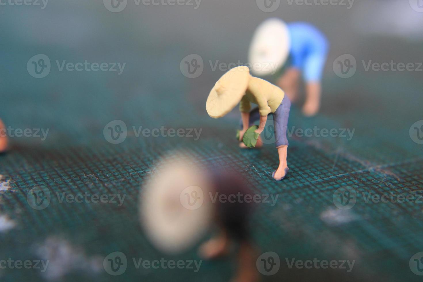 miniatuur figuren van boeren werken Aan een snijdend mat. concept van landbouw foto. foto
