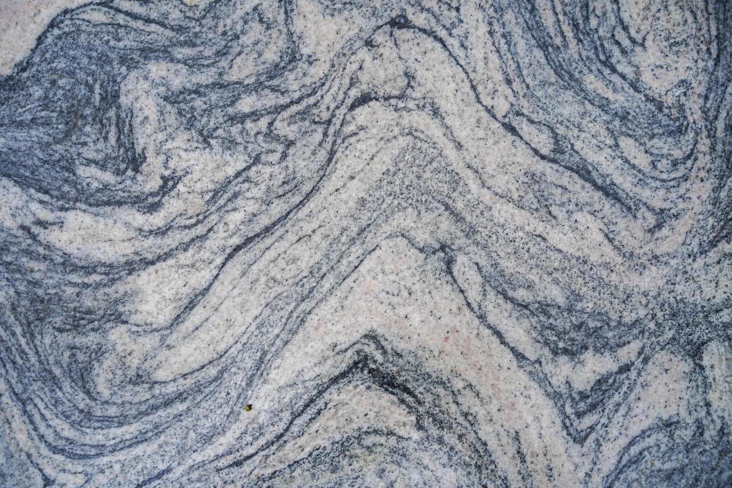 grijze steen met golvende patronen voor achtergrond of textuur foto