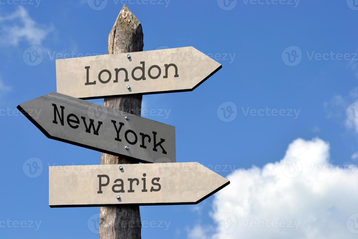 Londen, nieuw york, Parijs - houten wegwijzer met drie pijlen, lucht met wolken foto