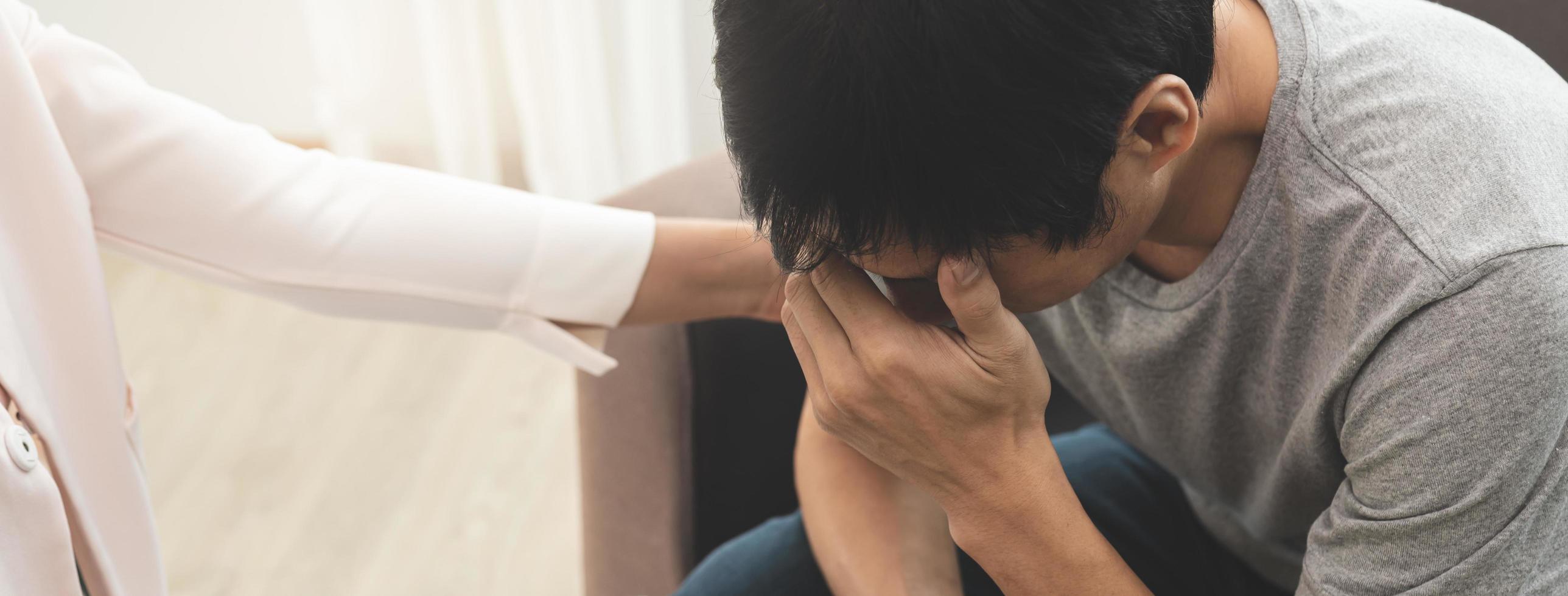 hand- van Aziatisch jong Mens, mannetje lijden van mentaal Gezondheid nodig hebben naar behandeling met psycholoog zittend Aan bankstel naar raadplegen, psychiater geven aanmoediging naar geduldig door aanraken naar maken zijn voelen ontspannen foto