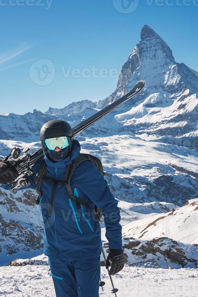 jong skiër genieten van zermatt ski toevlucht. mooi zonnig dag met een skiër omhoog in de bergen. sport- model. foto