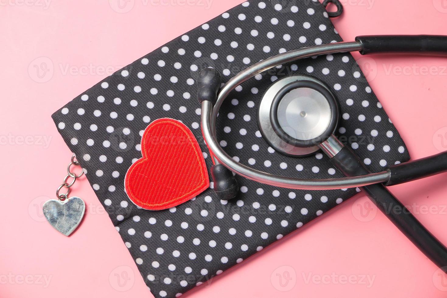 hartvormig symbool en stethoscoop op roze achtergrond foto