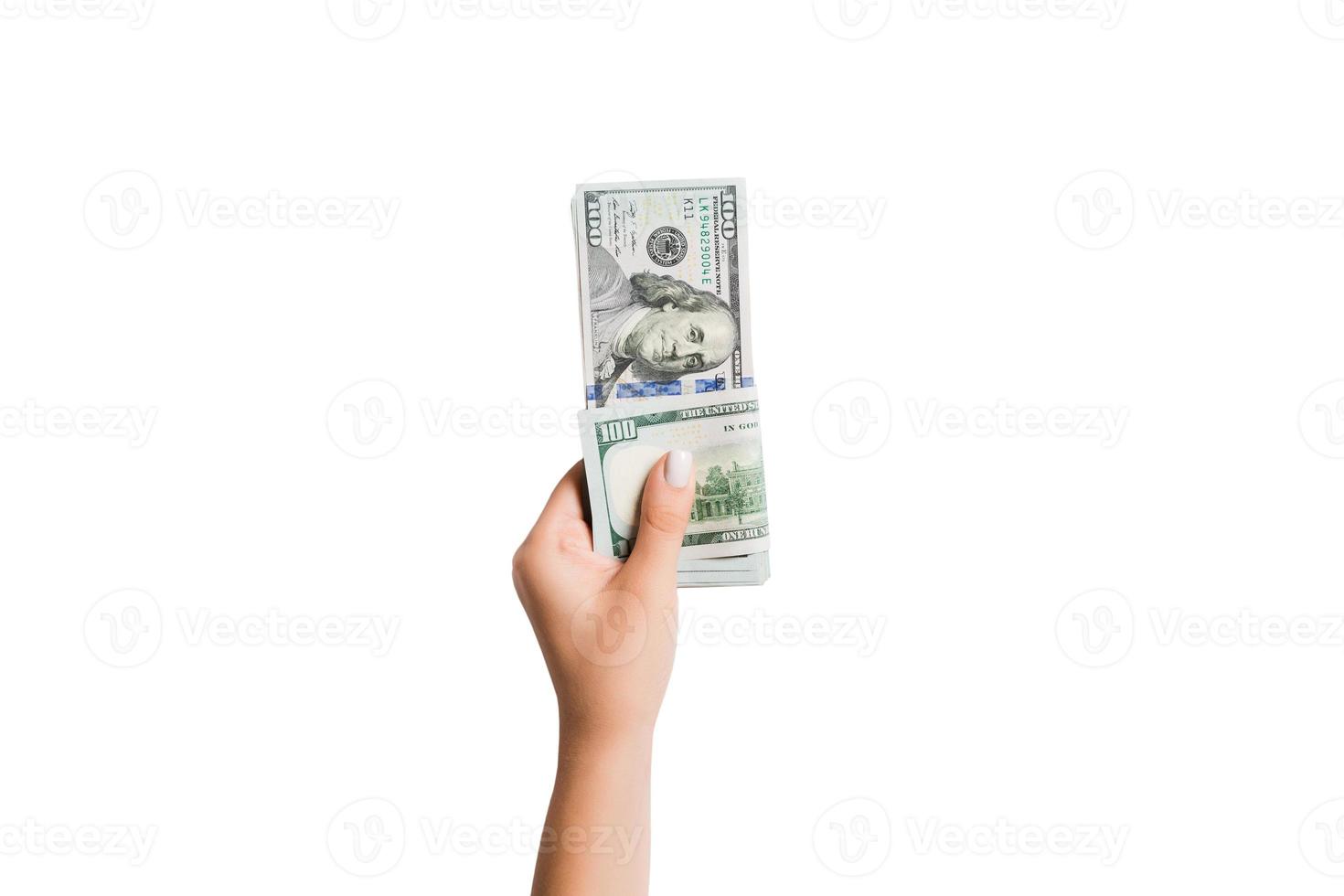 vrouw hand- geven geld Aan wit geïsoleerd achtergrond. top visie van dollar bankbiljetten. steekpenning concept. schuld en lening concept foto
