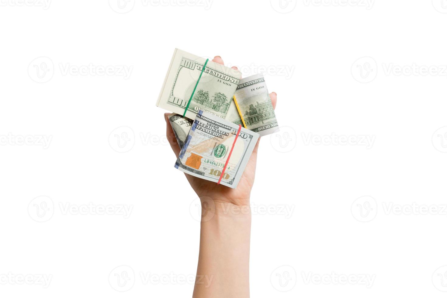 top visie van vrouw hand- Holding een veel van gerold omhoog dollar bankbiljetten Aan wit geïsoleerd achtergrond. armoede concept. credit concept met kopiëren ruimte foto