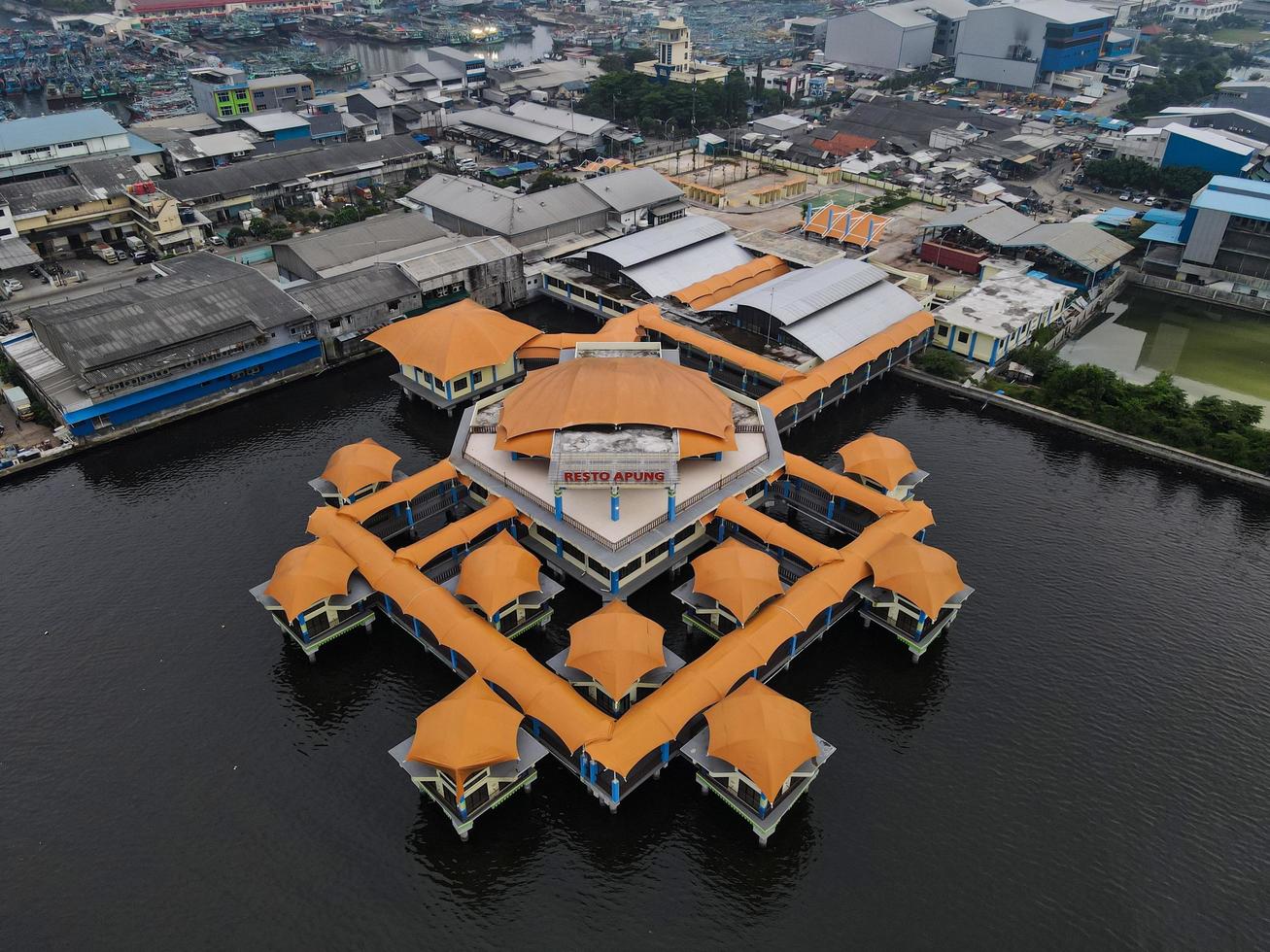 jakarta, indonesië 2021- luchtfoto drone-weergave van muara angke strand met houten boten die naast de pier leunen foto