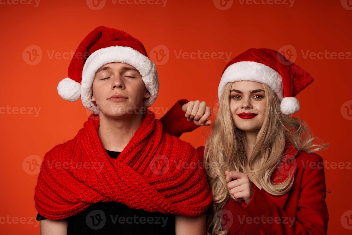 Mens en vrouw in nieuw jaar kleren Kerstmis vakantie rood achtergrond foto